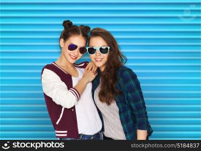 people, summer and fashion concept - happy smiling pretty teenage girls or friends in sunglasses over blue ribbed background. happy smiling pretty teenage girls in sunglasses