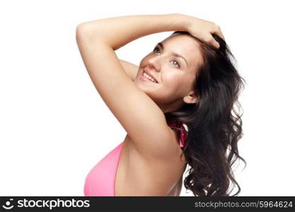people, summer, beauty and beach concept - happy young woman in pink swimsuit with long wavy hair