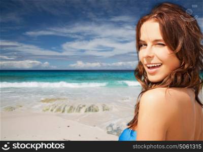 people, summer holidays, vacation and travel concept - happy smiling young woman over exotic tropical beach and ocean background. happy smiling woman on summer beach
