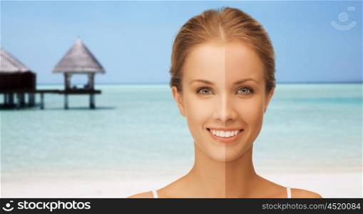 people, suntan, travel and summer holidays concept - close up of beautiful smiling woman with half face tanned over exotic tropical beach with bungalow background