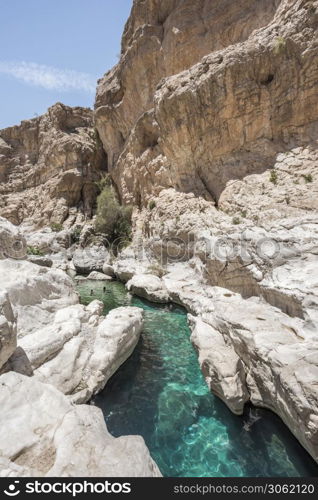 People swimming in the clear turquoise water of Wadi Bani Khalid, Sultanate of Oman, Middle East. People swiming in the pools of Wadi Bani Khalid, Oman