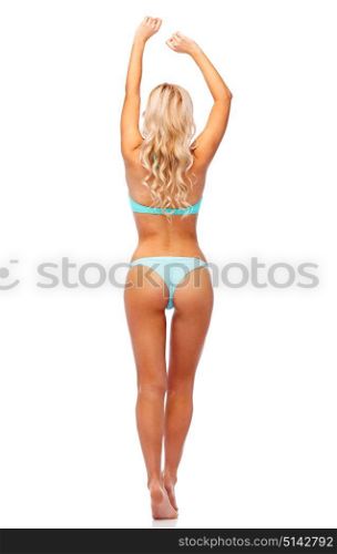 people, swimwear and summer concept - young woman in bikini swimsuit from back. woman in bikini swimsuit from back