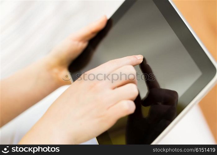 people, technology, advertisement and leisure concept - close up of woman hand with tablet pc computer black blank screen at home