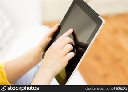 people, technology, advertisement and leisure concept - close up of woman hand with tablet pc computer black blank screen at home