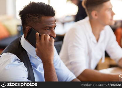 people, technology and communication concept - man calling on smartphone at bar or restaurant. man calling on smartphone at bar or restaurant