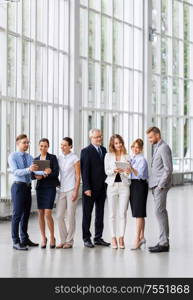 people, technology and corporate concept - business team with tablet pc computers at office. business people with tablet pc computers at office