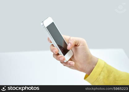 people, technology and internet concept - close up of teenage girl hand with smartphone at home