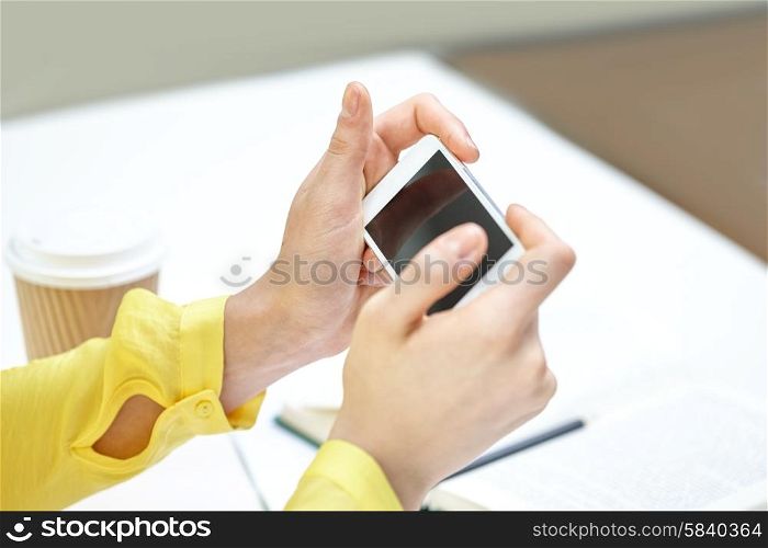 people, technology and internet concept - close up of teenage girl hands with smartphone at home