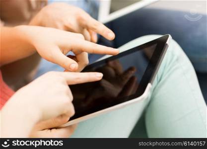 people, technology and leisure concept - close up of young women with tablet pc computer at home