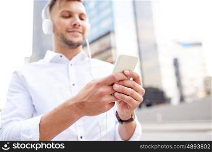 people, technology and lifestyle - man with smartphone and headphones listening music