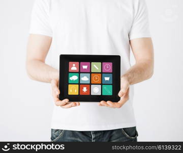 people, technology and media concept - close up of man with application icons on tablet pc computer