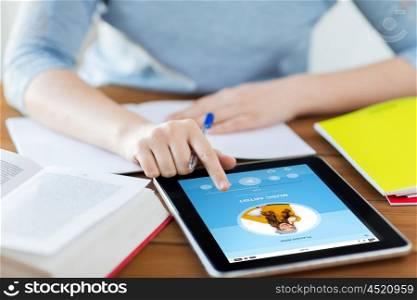 people, technology and media concept - close up of student woman with music player application on tablet pc computer and notebook at home
