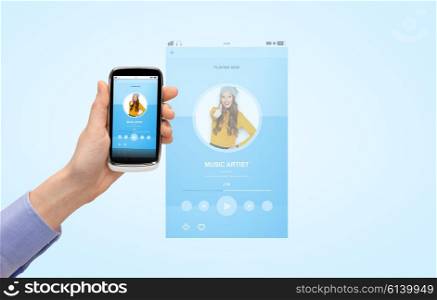 people, technology and media concept - close up of woman hand with smartphone and with music player