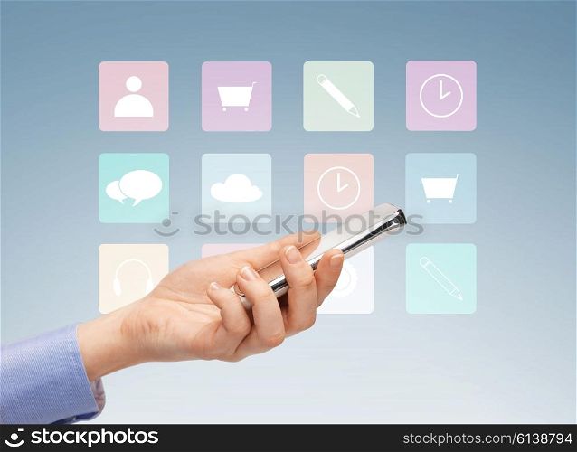 people, technology and media concept - close up of woman hand with smartphone and application icons