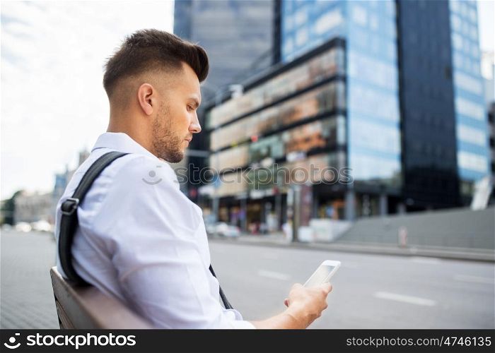 people, technology, communication and lifestyle - happy smiling young man with and bicycle sitting on city bench