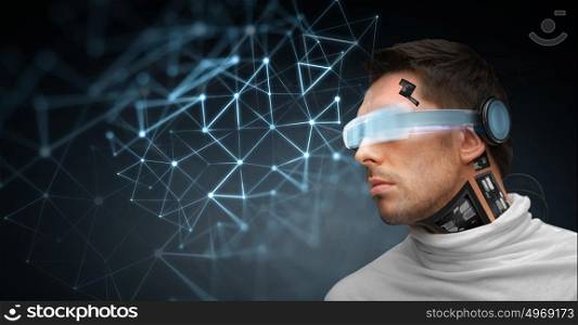 people, technology, future and progress - man with 3d glasses and microchip implant or sensors with virtual network projection over dark background. man with futuristic glasses and sensors