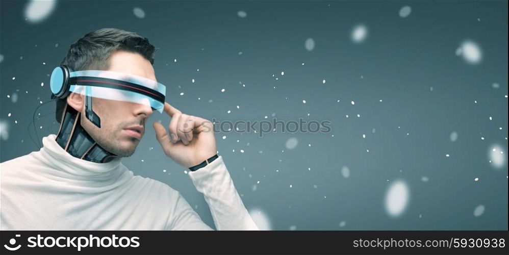 people, technology, future and progress - man with futuristic 3d glasses and microchip implant or sensors over gray background and highlights