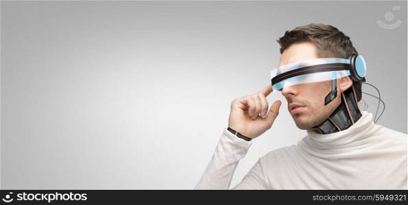 people, technology, future and progress - man with futuristic 3d glasses and microchip implant or sensors over gray background