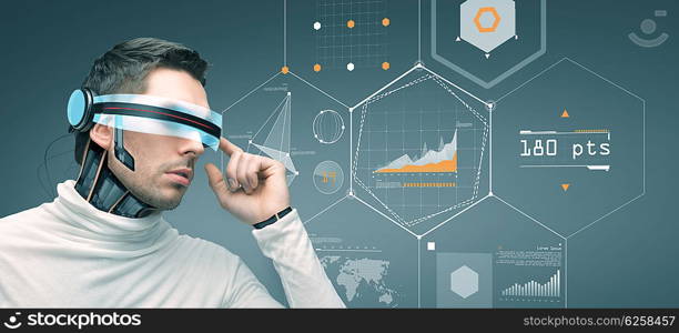 people, technology, future and progress - man with futuristic 3d glasses and microchip implant or sensors over gray background with virtual charts