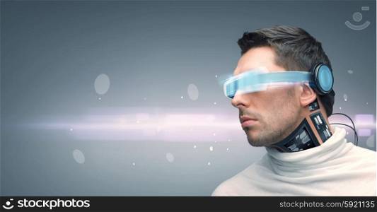 people, technology, future and progress - man with futuristic glasses and microchip implant or sensors over gray background and laser light