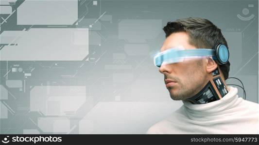 people, technology, future and progress - man with futuristic glasses and microchip implant or sensors over gray background and virtual screens