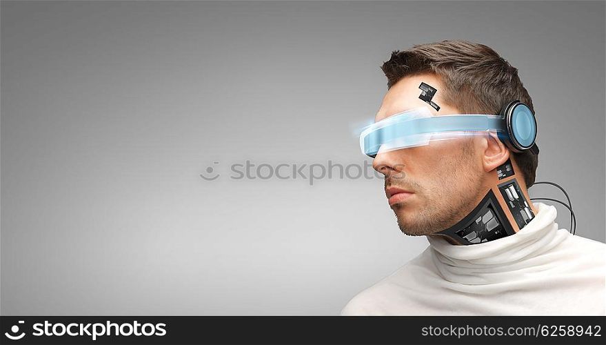 people, technology, future and progress - man with futuristic glasses and microchip implant or sensors over gray background