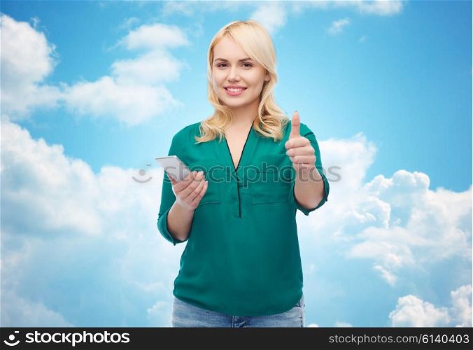 people, technology, gesture, communication and leisure concept - happy young woman with smartphone texting message over blue sky and clouds background