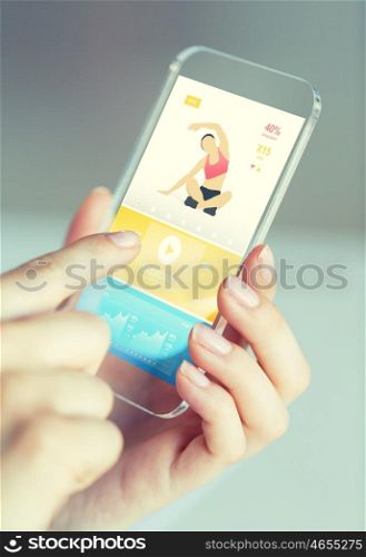 people, technology, sport and fitness concept - close up of female hand with smartphone with sports application on screen