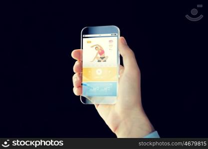 people, technology, sport and fitness concept - close up of male hand with smartphone with sports application on screen