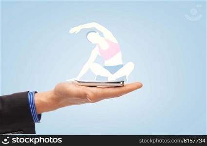 people, technology, sport and fitness concept - close up of male hand with smartphone and sports woman projection