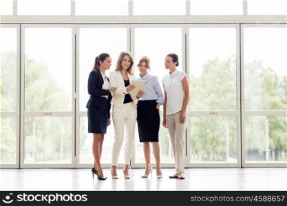 people, technology, work and corporate concept - business team of women with tablet pc computer at office