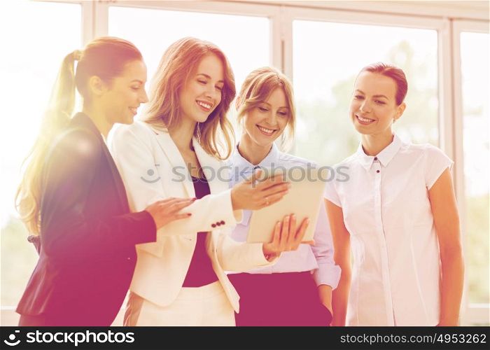 people, technology, work and corporate concept - business team of women with tablet pc computer at office. business people with tablet pc computer at office