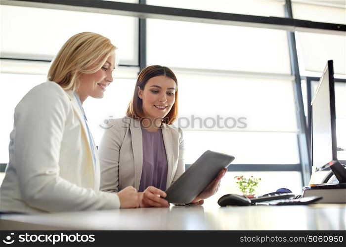 people, technology, work and corporate concept - business team of women with tablet pc computer at office. businesswomen with tablet pc computer at office