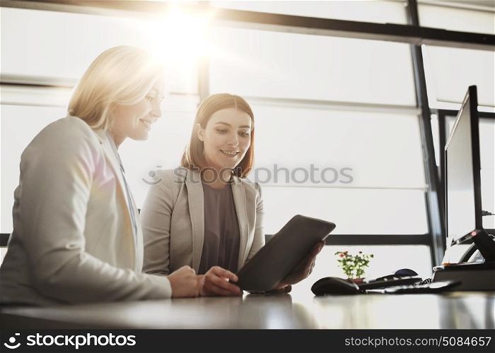people, technology, work and corporate concept - business team of women with tablet pc computer at office. businesswomen with tablet pc computer at office. businesswomen with tablet pc computer at office