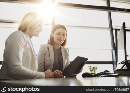 people, technology, work and corporate concept - business team of women with tablet pc computer at office. businesswomen with tablet pc computer at office. businesswomen with tablet pc computer at office