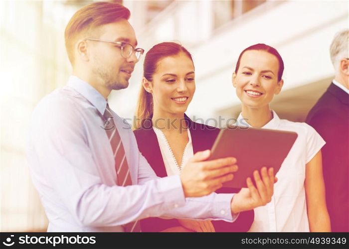 people, technology, work and corporate concept - business team with tablet pc computer at office. business people with tablet pc computer at office