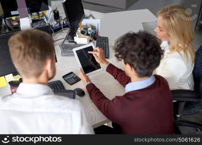 people, technology, work and corporate concept - business team with tablet pc computer at office. business team with tablet pc at office