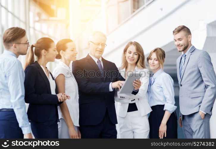 people, technology, work and corporate concept - business team with tablet pc computer at office. business people with tablet pc computer at office