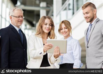 people, technology, work and corporate concept - business team with tablet pc computers at office