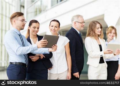 people, technology, work and corporate concept - business team with tablet pc computers at office