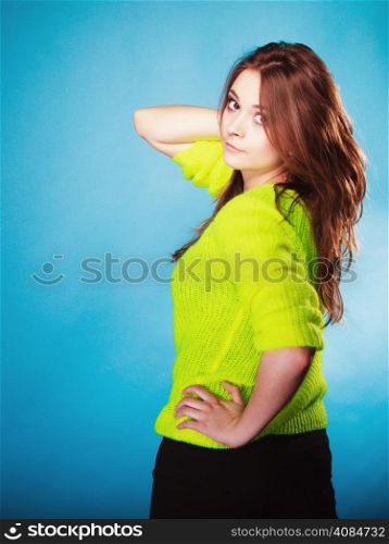People teenage concept. Portrait young fashion woman teen girl wearing vivid colour sweater on blue