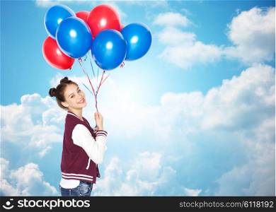 people, teens, holidays and party concept - happy smiling pretty teenage girl with helium balloons over blue sky and clouds background
