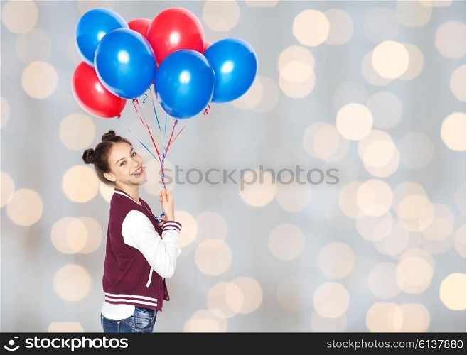 people, teens, holidays and party concept - happy smiling pretty teenage girl with helium balloons over lights background