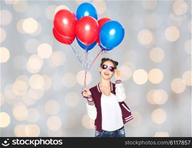 people, teens, holidays, party and summer concept - happy smiling pretty teenage girl in sunglasses with helium balloons over lights background