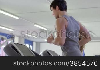 People training in fitness club, gym and sport activity. Young man and woman working out and running on treadmill, athletes with wellness equipment. 2of27