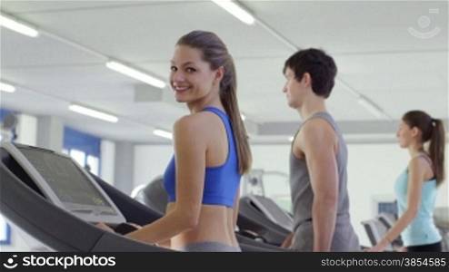 People training in fitness club, gym and sport activity. Young woman working out and jogging on treadmill, portrait of happy female athlete with wellness equipment. Sequence, 4of27