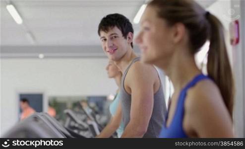 People training in fitness club, gym and sport activity. Young man working out and running on treadmill, portrait of happy male athlete with wellness equipment. 4of27