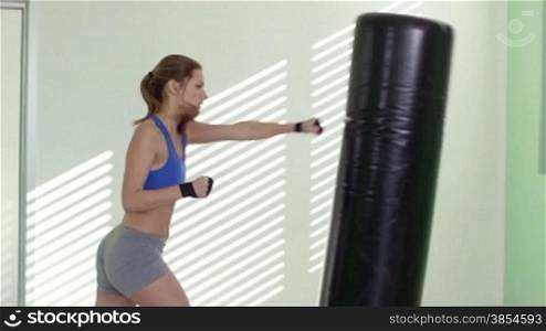 People training in fitness club, gym and sport activity. Pretty young woman working out, boxing and kicking, exercising for self-defense. 10of27