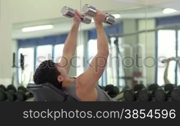 People training in fitness club, gym and sport activity. Young man working out with weights, strong male athlete with wellness equipment. 14of27