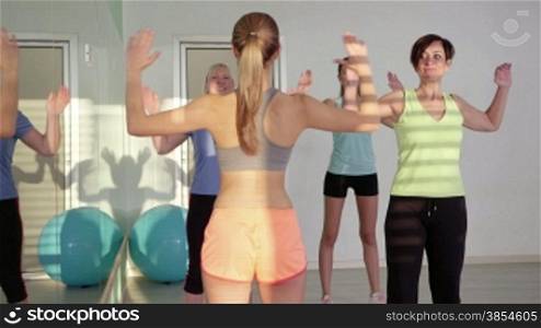 People training in fitness club, gym and sport activity. Group of women with personal trainer exercising in pilates lesson. 23of27